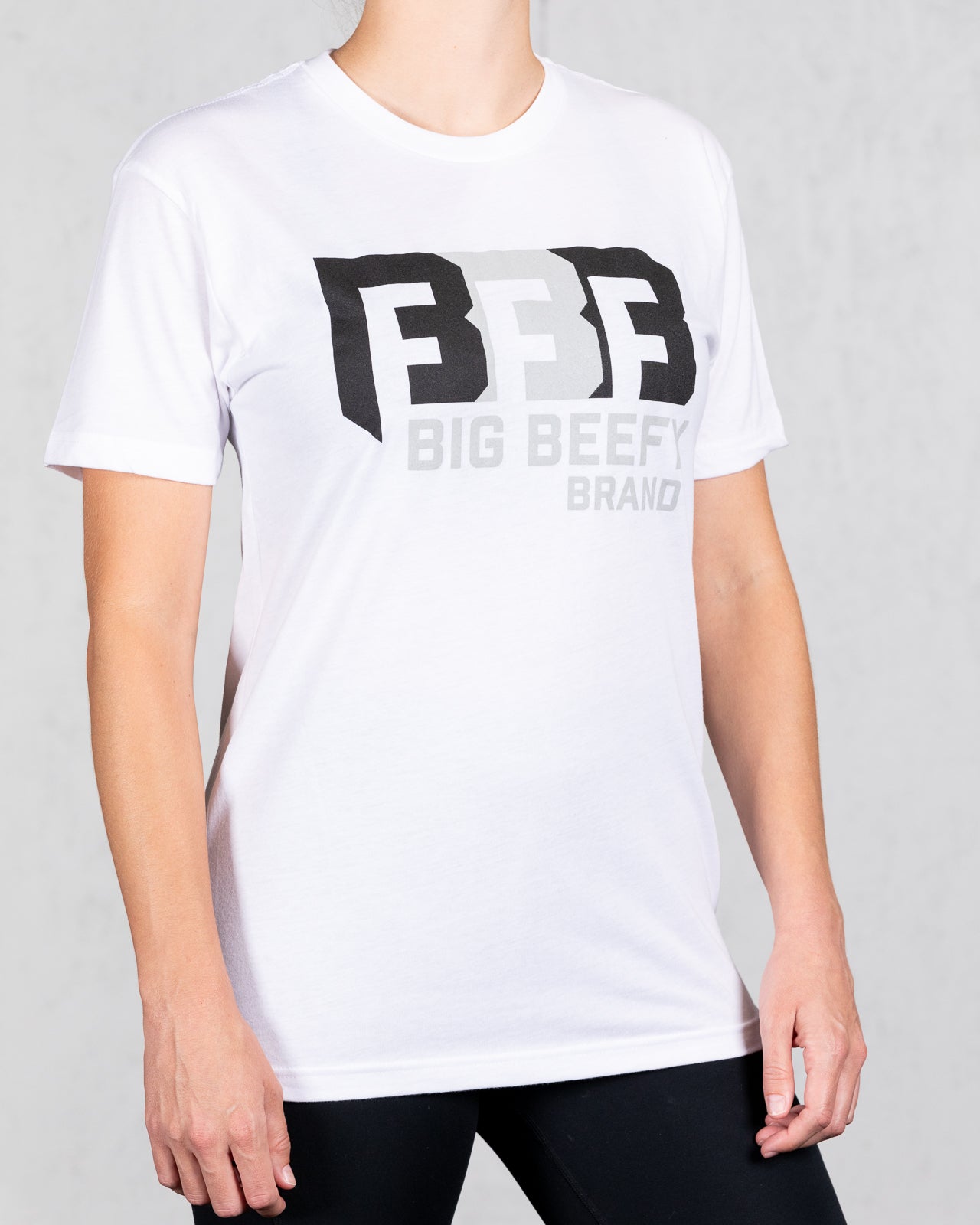 woman wearing white big beefy brand tee