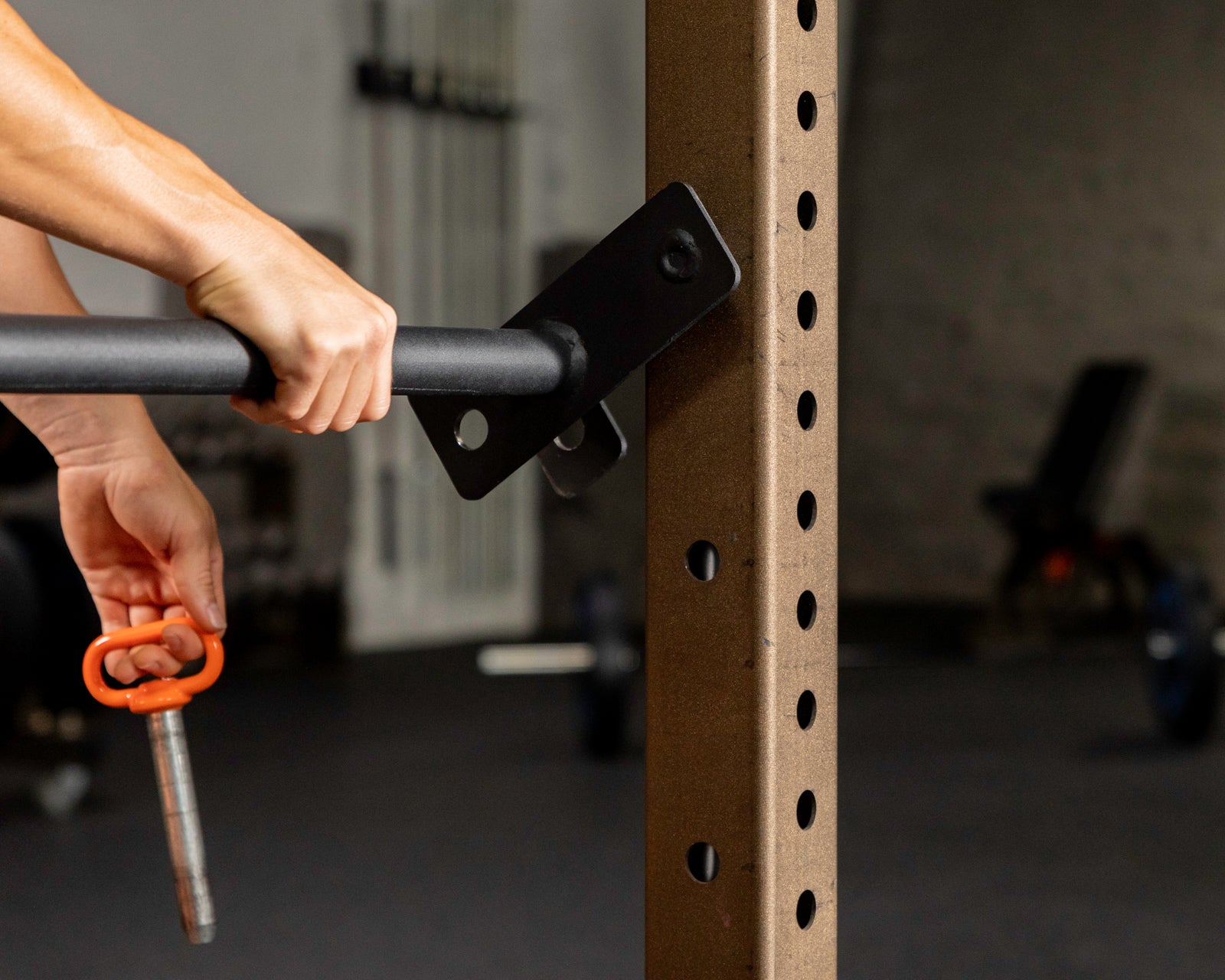 person in motion of attaching the c-4 adjust a bar to a rig