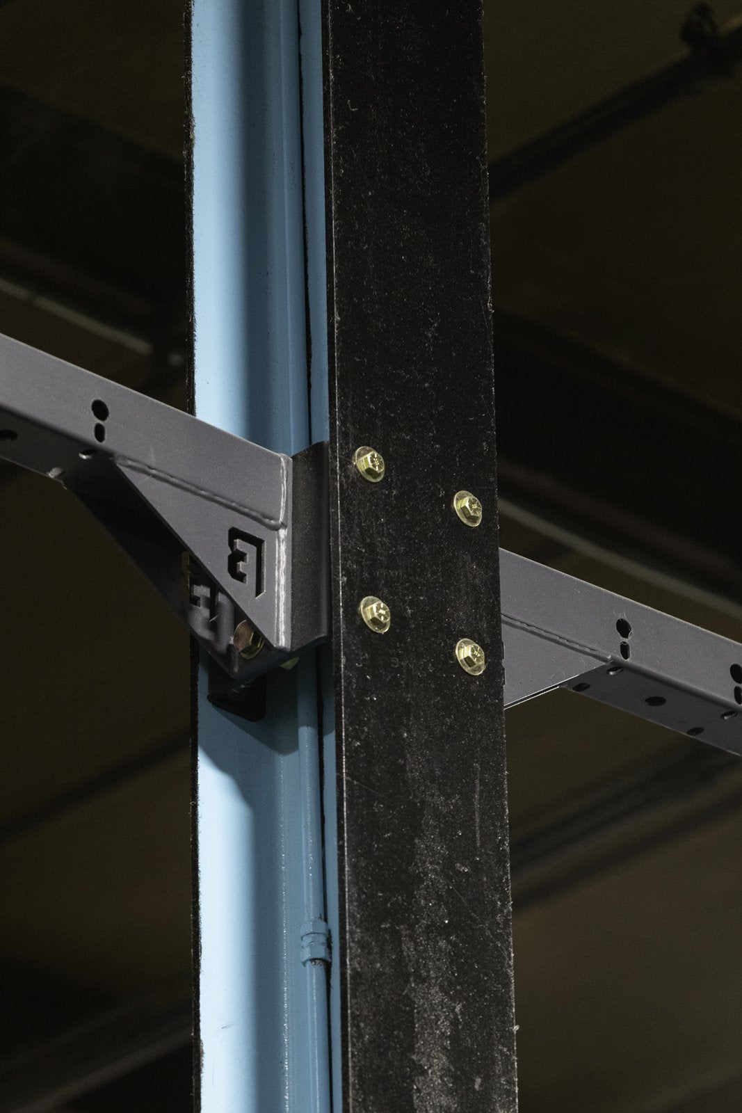 Detail of a BUILT rig crossmember joint with yellow zinc hardware