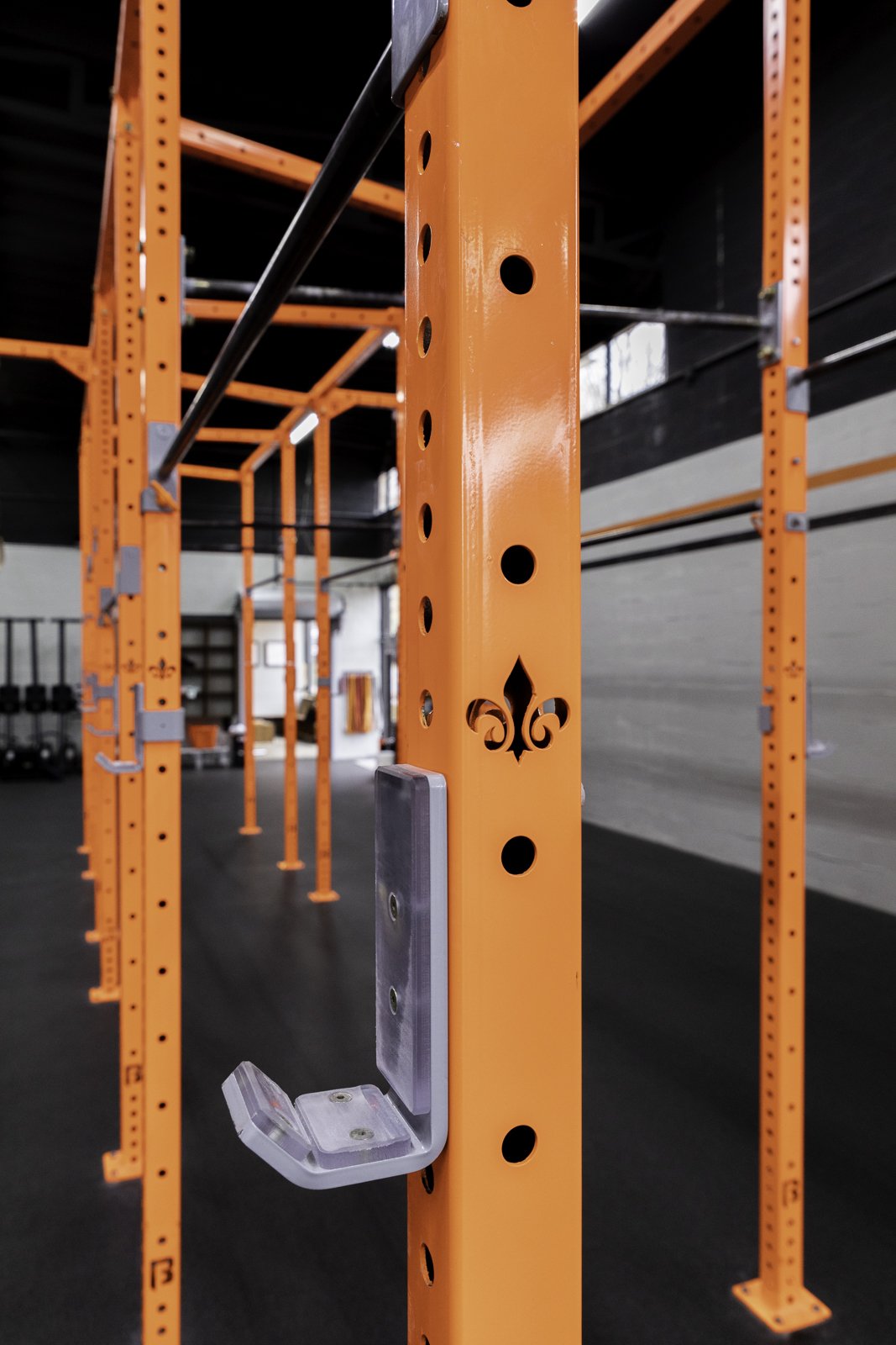 Orange BUILT rig upright with J-cup and fleur-de-lis cutout