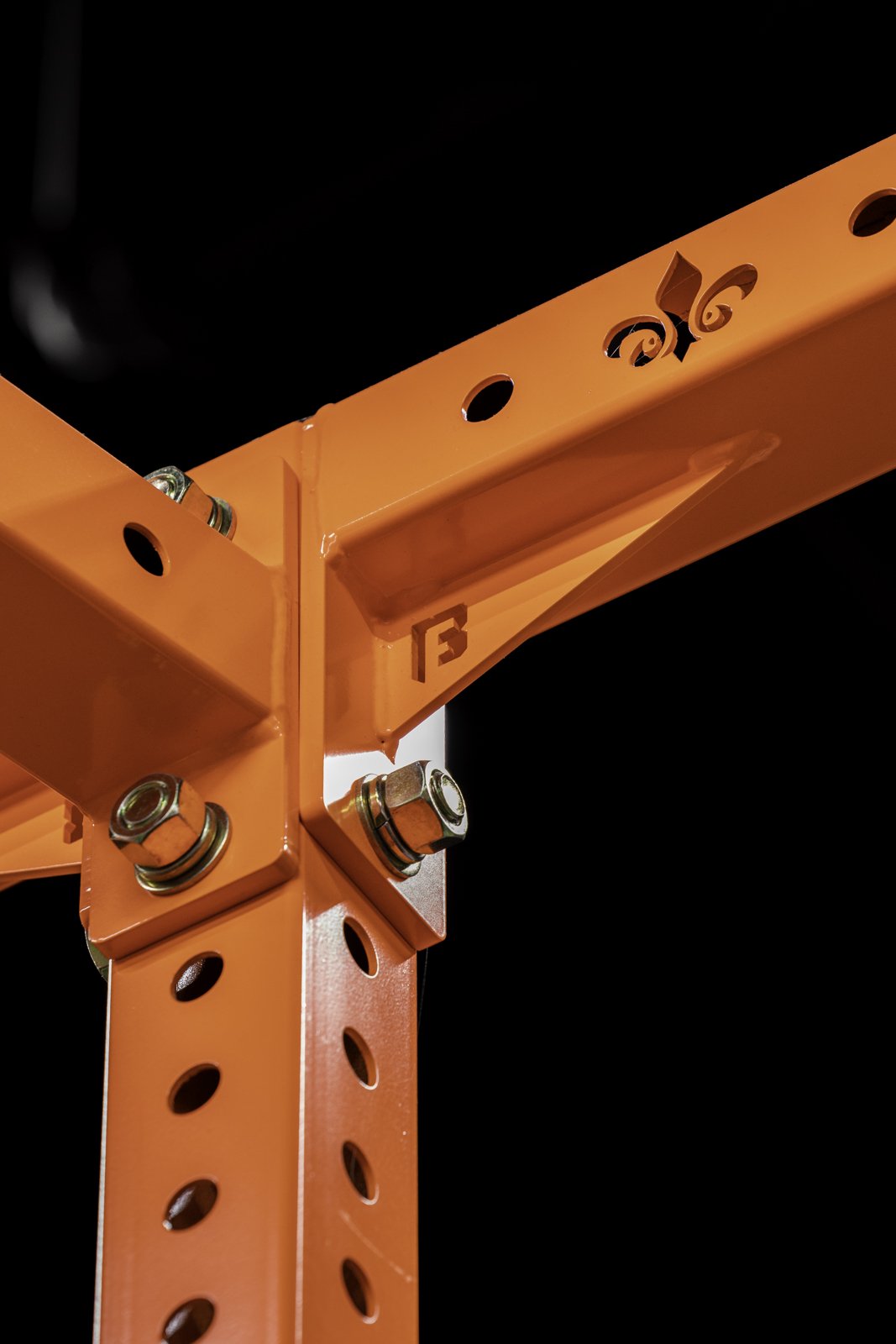 Detail of an orange BUILT rig joint with custom fleur-de-lis cutout