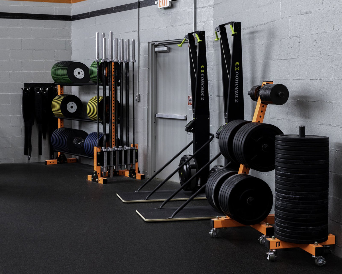 Orange BUILT storage with bumper plates, medicine balls and barbells