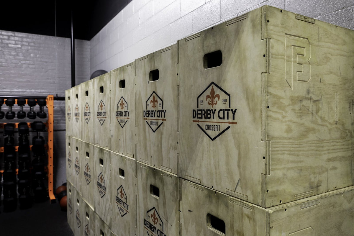 Branded plyo boxes stacked at Derby City CrossFit