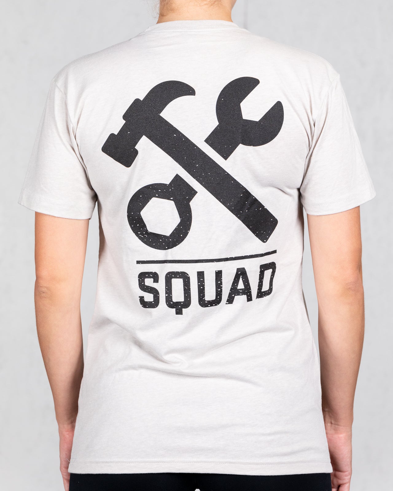 woman wearing sand colored squad tee from back