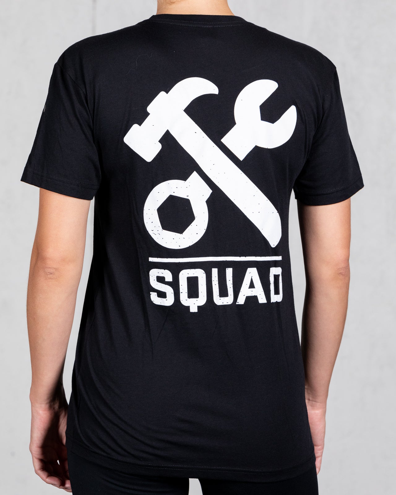 woman wearing black squad tee from back