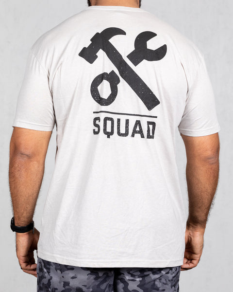 man wearing sand colored squad tee from back